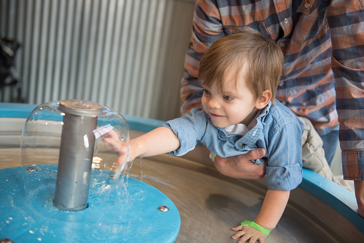 woman trying the pollen lift exhibit